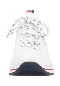White athletic shoe with a textured knit upper, rounded toe, and contrasting black sole. Features braided laces and a striped heel tab.