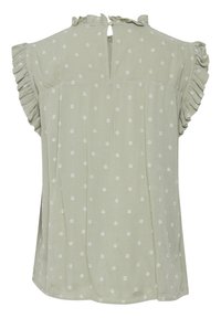 Blusa verde claro con lunares blancos, mangas rizadas y cierre de llave en la parte posterior. Tejido suave con un acabado texturizado.
