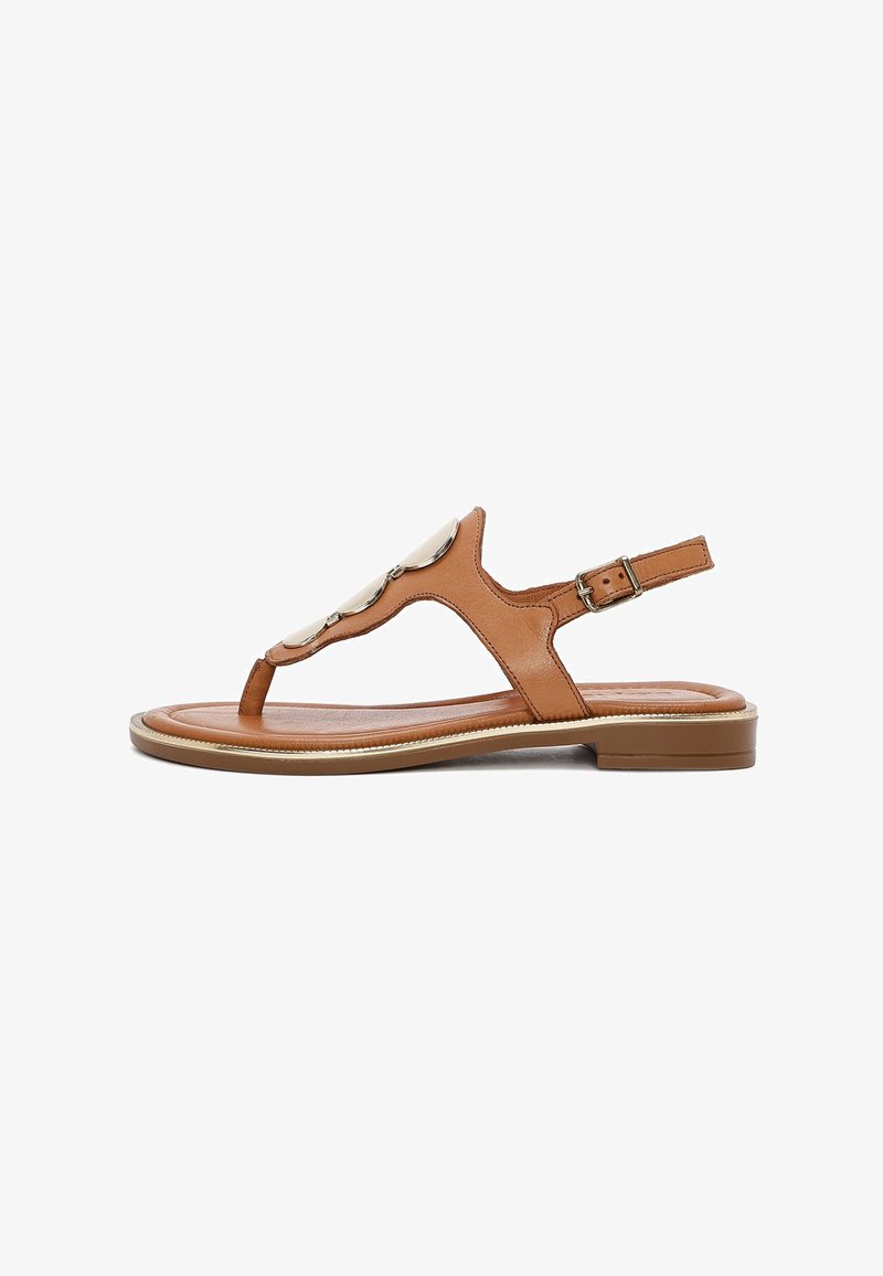 Brown leather sandal with a toe loop, adjustable ankle strap, and decorative metallic accents on the upper. Flat sole.