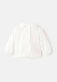 Bela bombažna srajca z dolgimi rokavi, zaobljenim ovratnikom, zapiranjem na gumbe zadaj in nabranimi manšetami. Enostaven, čist dizajn.
