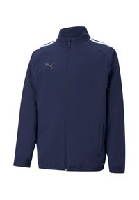 Marineblauwe sportjack met een opstaand kraag, ritsluiting, zijzakken, witte strepen op de schouders en een reflecterend logo op de borst.