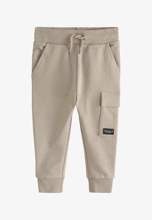 Beige bomulsjoggingbukser med ribbet talje og manchetter, snøre lukning, sidelommer og en lomme på låret.
