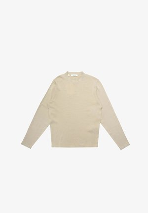 Top beige a maniche lunghe con scollo rotondo, realizzato in tessuto liscio. Presenta una texture a coste e un taglio dritto all'orlo.