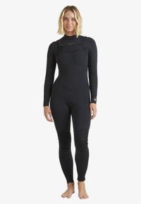 Black neoprene wetsuit with long sleeves, a high neck, paneling, and textured knee pads. Designed for aquatic activities, fitted silhouette.