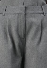 Gray wool trousers with a tailored design, featuring pleats, side pockets, and a straight leg cut. Smooth texture with a subtle sheen.