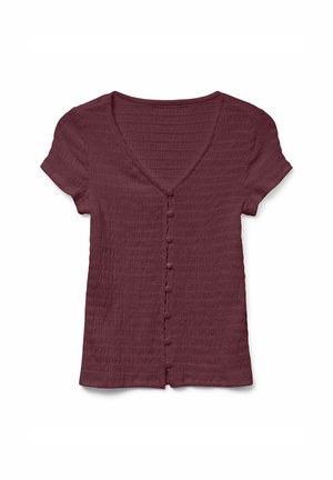 V-ringad, kortärmad bordeaux topp med texturerad tyg och knappdetaljer fram. Har en figurnära design och mjuk, ribbad textur.