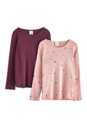 Two long-sleeve tops: one in dark purple with a textured pattern, the other in light pink with small floral prints and scalloped hems.