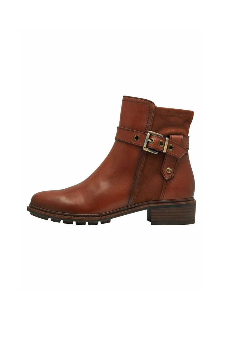 Bottine en cuir marron avec un talon épais, détail de boucle sur la sangle et tissu texturé en haut. Semelle robuste pour une meilleure adhérence.