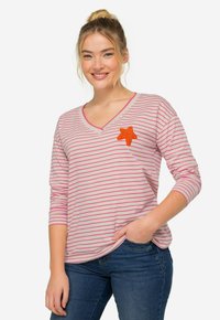 Camisa de manga larga con cuello en V de rayas rosas y blancas, con un parche con forma de estrella naranja en el pecho, fabricada con tela suave.