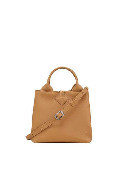 Tan leather handbag with a structured shape, top handles, and an adjustable shoulder strap. Features a textured surface and a triangular detail.