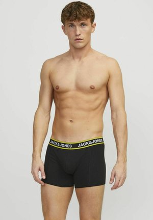 Schwarze Boxer-Shorts mit einem gelben und weißen Markenelastikbund. Hergestellt aus weichem, dehnbarem Material, mit einer figurbetonten Passform und einer Länge bis zur Mitte des Oberschenkels.