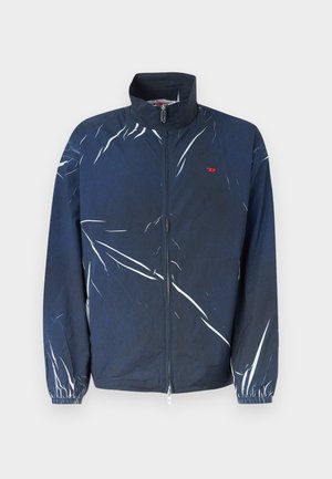 Marineblå glidelåsjakke med hvite abstrakte striper, elastiske mansjetter og en liten rød logo på venstre bryst.