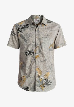 Chemise beige à manches courtes avec boutons, motifs de feuilles tropicales et de fleurs en noir, jaune et gris, avec une poche poitrine.