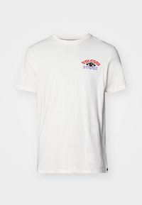 White cotton t-shirt featuring short sleeves and a round neckline. Front graphic in red and purple text reads "VOLCOM STORE" with a black accent.
