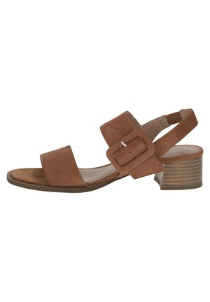 Sandale ouverte à bout ouvert en daim marron, talon bloc bas, larges brides et une grande boucle ajustable à la cheville.