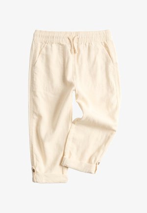 Pantalon décontracté beige clair avec taille élastique, cordon de serrage, poches avant, revers roulés et détails à boutons à la cheville.