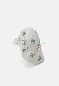 Cotton bucket hat with a light beige base, featuring a repetitive green crab pattern, a wide brim, and a tie closure at the back.