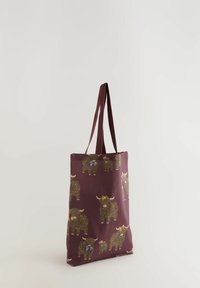 Maroon tote bag featuring a repeated pattern of illustrated Highland cattle with bows. Made from durable fabric with two sturdy handle straps.