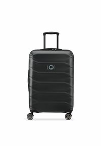 Black hard-shell suitcase with textured surface, featuring a rectangular shape, retractable handle, four wheels, and a circular logo detail.