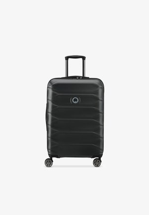 Black hard-shell suitcase with textured surface, featuring a rectangular shape, retractable handle, four wheels, and a circular logo detail.