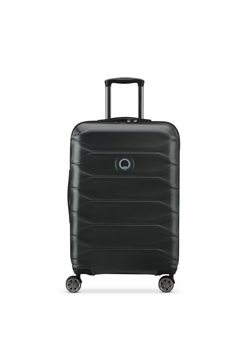 Black hard-shell suitcase with textured surface, featuring a rectangular shape, retractable handle, four wheels, and a circular logo detail.
