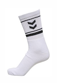 Weiße Socke mit gerippter Struktur, ausgestattet mit schwarzen horizontalen Streifen und einem Zickzackmuster. Entworfen für die Passform bis zur Mitte der Wade.