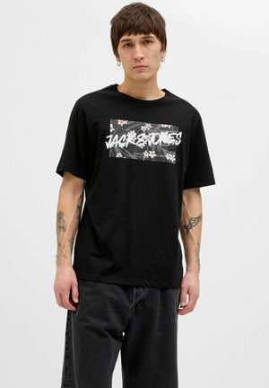 Black cotton t-shirt featuring a floral graphic print and white text. Short sleeves, round neck, relaxed fit, and subtle texture.