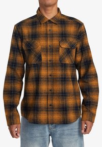 Karobluse aus Flanell mit orange-blauem Muster, langen Ärmeln, Button-Down-Kragen, zwei Brusttaschen und strukturiertem Stoff.