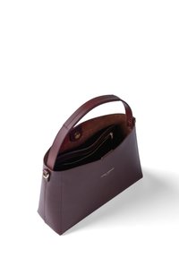 Braune Leder-Handtasche mit strukturiertem Design, ausgestattet mit einem oberen Griff, einem Reißverschlussfach und goldenen Hardware-Akzenten. Das Innere ist mit Wildleder ausgekleidet.