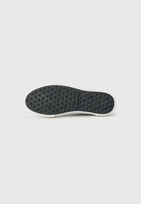 Black rubber shoe sole with a textured diamond pattern, white edging, and branding text "KARL LAGERFELD" embossed in the center.