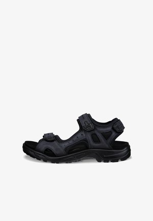 Schwarze sportliche Outdoor-Sandale mit verstellbaren Riemen und robuster Sohle, entworfen für Komfort und Langlebigkeit.