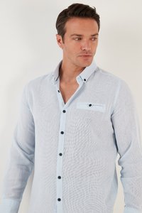 Lichtblauwe overhemd met lange mouwen, gemaakt van een gestructureerde stof. Beschikt over een button-down kraag, donkere knopen en een borstzak met klep.