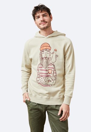 Sudadera beige de tela suave con un gráfico frontal de un hombre barbudo y un pájaro. Presenta una capucha con cordón y puños y dobladillo acanalados.