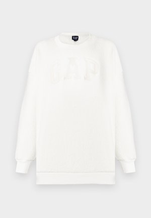 Sudadera blanca de forro polar con puños y dobladillo acanalados, con un gran logo "GAP" en relieve de color claro en la parte delantera.