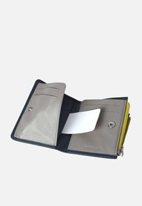 Leather wallet with gray and navy sections. Features multiple card slots, a snap closure, and a zippered compartment with a yellow accent.