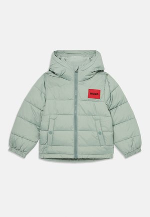 Padded jacket in light green fabric with a hood, front zip closure, side pockets, and a red "HUGO" logo patch on the chest.