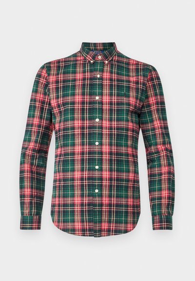 Camisa de botão em padrão xadrez verde com detalhes em vermelho e azul-marinho. Apresenta mangas longas, colarinho pontudo e cinco botões na frente. Material em algodão.