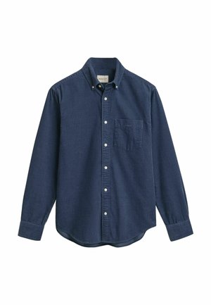 Chemise boutonnée bleu marine en coton doux avec une poche poitrine, des manches longues et un ourlet arrondi. Col classique avec des boutons blancs.