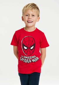 Red cotton t-shirt featuring a Spider-Man graphic with a black web-patterned mask and white eyes. Text below reads "the AMAZING SPIDER-MAN."