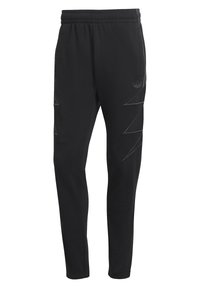 Černé sportovní kalhoty s elastickým pasem, zeštíhleným střihem a jemnými šikmými pruhy na bocích. Vyrobeno z měkké tkaniny.