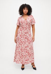 Pink patterned maxi dress with short sleeves, featuring white floral designs and a V-neckline. Accented with a flowing silhouette.