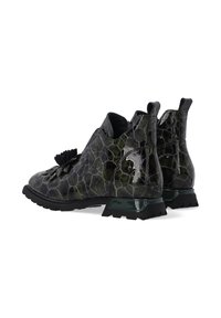 Błyszczące, ciemnozielone skórzane buty w wzór krokodylej skóry z frędzlami, niskimi słupkowymi obcasami i pętlami z tyłu, na białym tle.