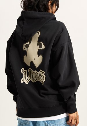 Black hoodie made of thick fabric, featuring a large beige graphic of a bear and stylized text on the back, back hem ribbed.