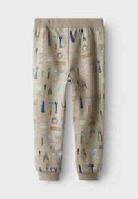 Beige Sweatpants mit einem werkzeugthematischen Druck in verschiedenen Farben, ausgestattet mit einem elastischen Bund und Bündchen für eine figurbetonte Passform.