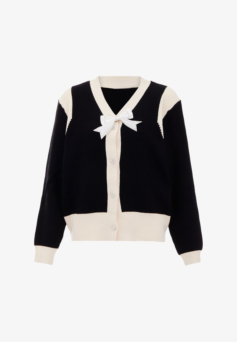 Zwart en crèmekleurig gebreid vest met V-hals, vijf knopen en een witte strikdetail bij de hals. Heeft een geribbelde structuur en contrasterende panels.