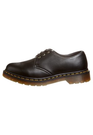 Black leather derby shoe with three eyelets, yellow-stitched welt, and thick translucent rubber sole.
