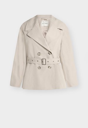 Beige double-breasted women's jacket with wide lapels, four buttons, and a matching belt with a rectangular buckle at the waist.