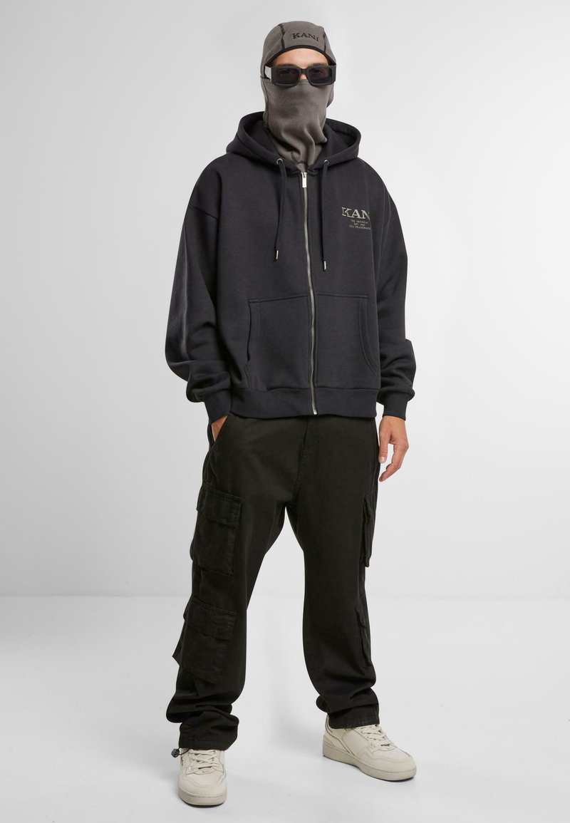Karl Kani Sweater met rits zwart Karl Kani Sweater met rits zwart