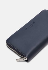 Portafoglio in pelle blu navy con zip intorno, dotato di zip argentata e logo "LIEBESKIND BERLIN" in rilievo sul davanti.