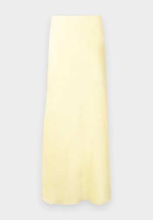 Απαλό κίτρινο, μακρύ μέχρι τον αστράγαλο, φούστα με ίσια γραμμή και λεία υφή, τοποθετημένη μπροστά σε ανοιχτό γκρι φόντο.